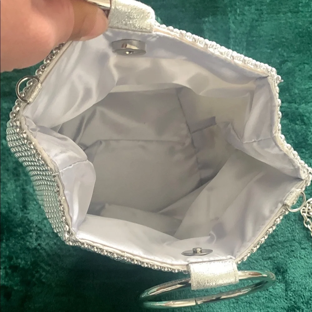 NWOT Silver Wristlet. Metal Handle & crossbody chain strap.